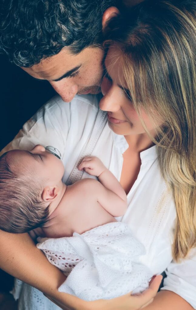 A couple holding a newborn baby