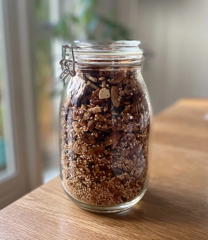 A glass jar filled with crunchy nut granola