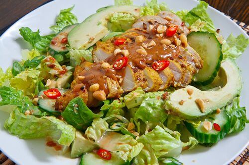 A plate of 'fake away' chicken satay served over a salad