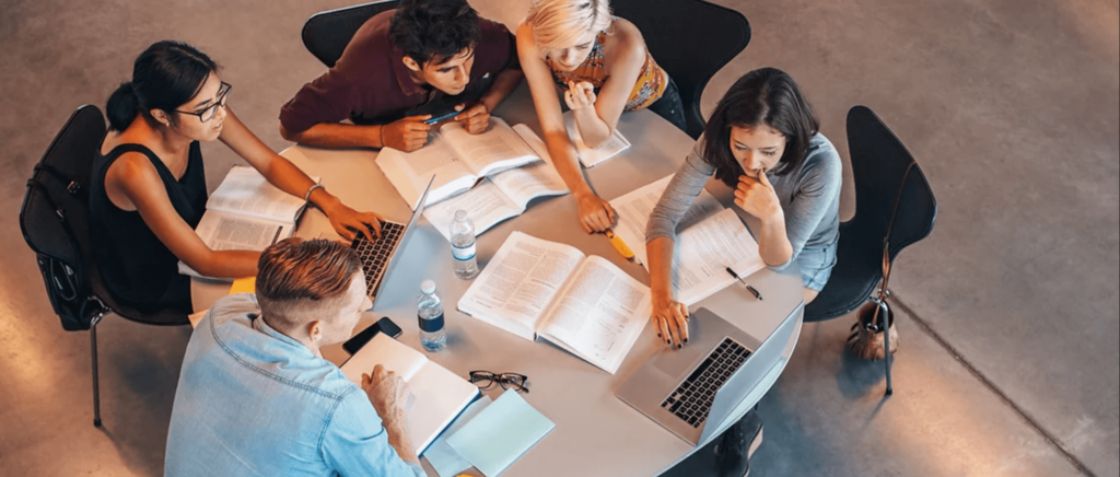 A group of friends studying together at a round table